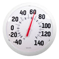 Close up of a large bold Fahrenheit dial thermometer with a red needle.