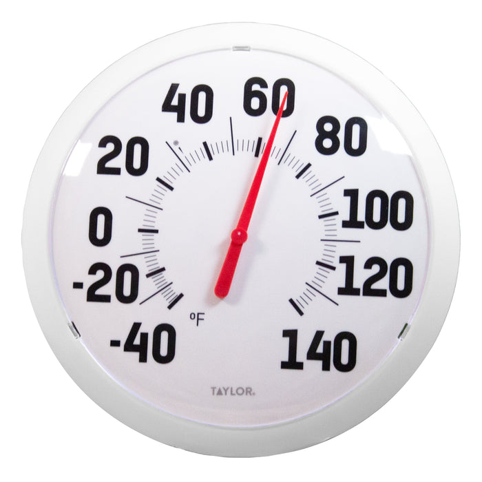 Close up of a large bold Fahrenheit dial thermometer with a red needle.