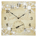 Square wooden clock with white snowflakes, bold black numerals around the edge, and a thermometer dial at the bottom.