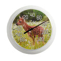 Close-up of a white framed outdoor thermometer featuring a fawn on a green dial