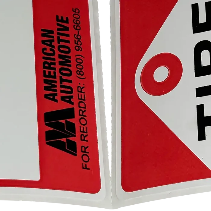 Red and white AA Tire Labels on a roll, perfect for new tire labels and sales