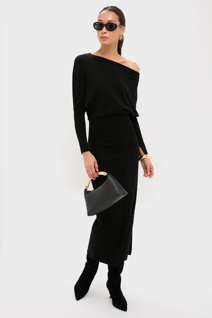 Woman in black off-the-shoulder dress, wearing classic Apple Organic Hoops. The gold hoops add effortless elegance and fun to her high-end look.