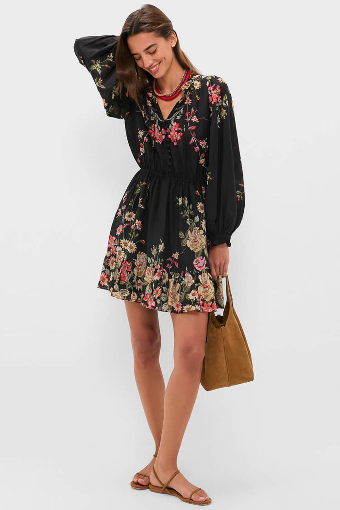 Young woman models the classic Barrel Red Statement Necklace, effortlessly pairing it with a floral-print dress and tote bag for a fun, high-end look.