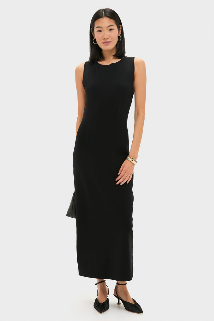 Woman in a sleeveless black maxi dress wears the classic Berry Gem Petite Hinged Bangle - Malachite, adding an effortless, high-end touch to her ensemble.