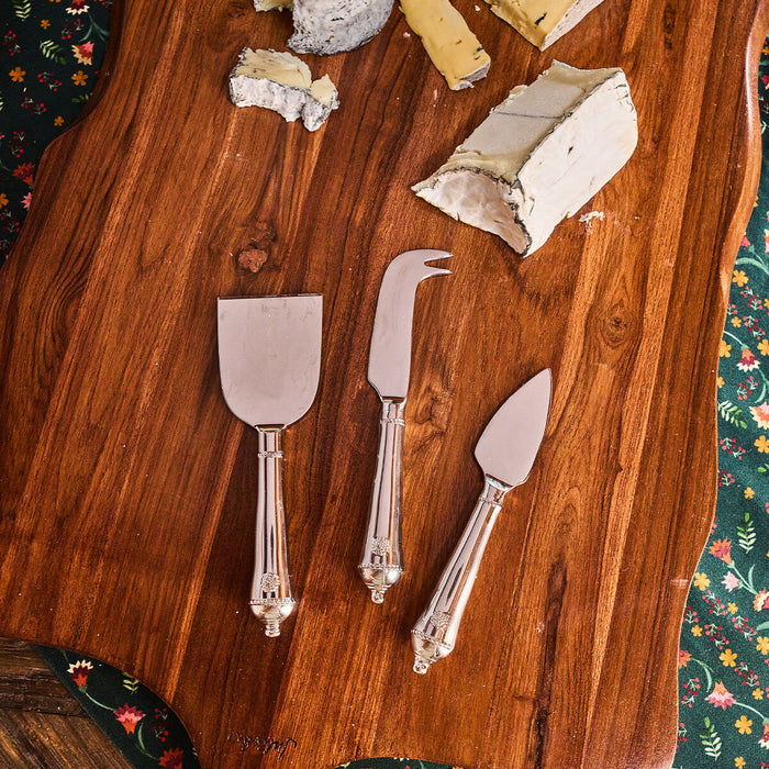 Classic Berry & Thread Cheese Knife Assorted Set of 3 on a wooden board with soft cheese, embodying effortless entertaining with a fun, high-end touch.