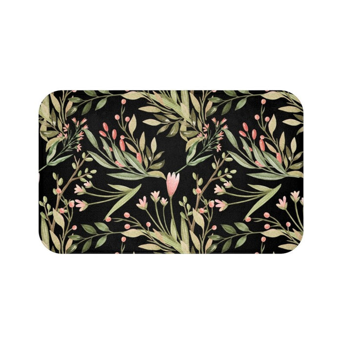 A rectangular memory foam mat with a black and green floral pattern on it.