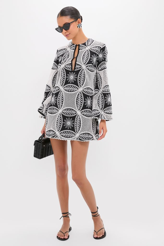 Model showcasing Black Maris Earrings with sculptural silhouette, adding a classic and effortless high-end touch to her fun lace dress ensemble.