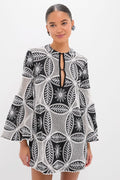 Young woman wearing the classic Black Plain Gia Mini Dress with an effortless lace-inspired pattern and keyhole neckline, exuding a high-end, fun, confident style.