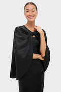 Classic elegance meets effortless style with the Black Satin Mountbatten Cape, draped over a form-fitting dress, perfect for a high-end, fun, and confident look.