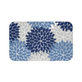 A rectangular memory foam mat with a muted color scheme consisting of a blue, light blue, and light gray floral pattern against a white background, with anti-slip backing.