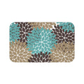 Memory foam mat featuring a white background and flower petal bursts in teal, brown, and light brown.
