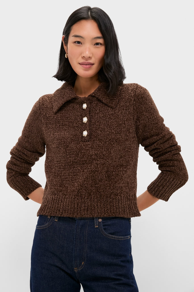 Woman wearing the Brown Fraser Sweater, a classic, effortless knit with pearl-like buttons, paired with high-waisted jeans, embodying a fun, high-end style.
