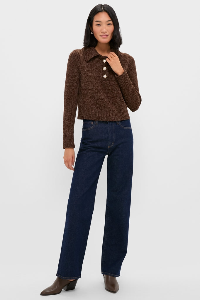 Model wearing the Brown Fraser Sweater, a classic, effortless knit with a polo collar and three-button placket, paired with high-waisted jeans, embodying high-end, fun style.