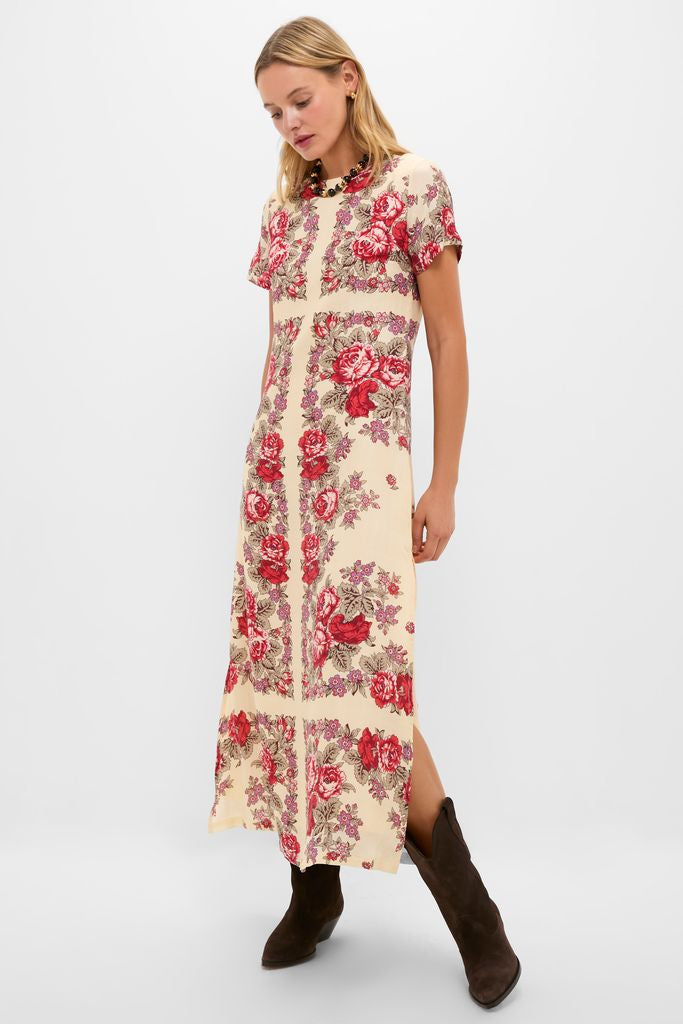 Woman models a classic, high-end dress with a floral print, accessorized with the effortless, fun Brown Tommie Necklace and dark brown ankle boots.