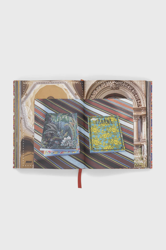 Cabana Anthology: The Anniversary Edition, a classic hardcover coffee-table book, showcases effortlessly high-end design with vibrant, decorative Cabana magazines displayed on its open pages.