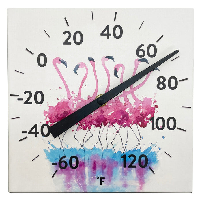 Close up of a Ceramic Flamingo thermometer with bold black numbers and pink flamingo artwork on a white background