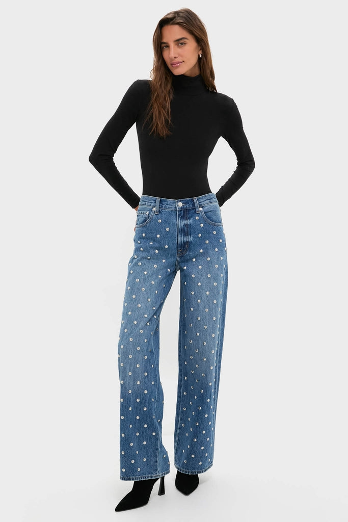 Model wearing Charmed Hendrix High Rise Baggy jeans with crystal studs, paired with a classic black turtleneck and heeled ankle boots for an effortless, high-end look.