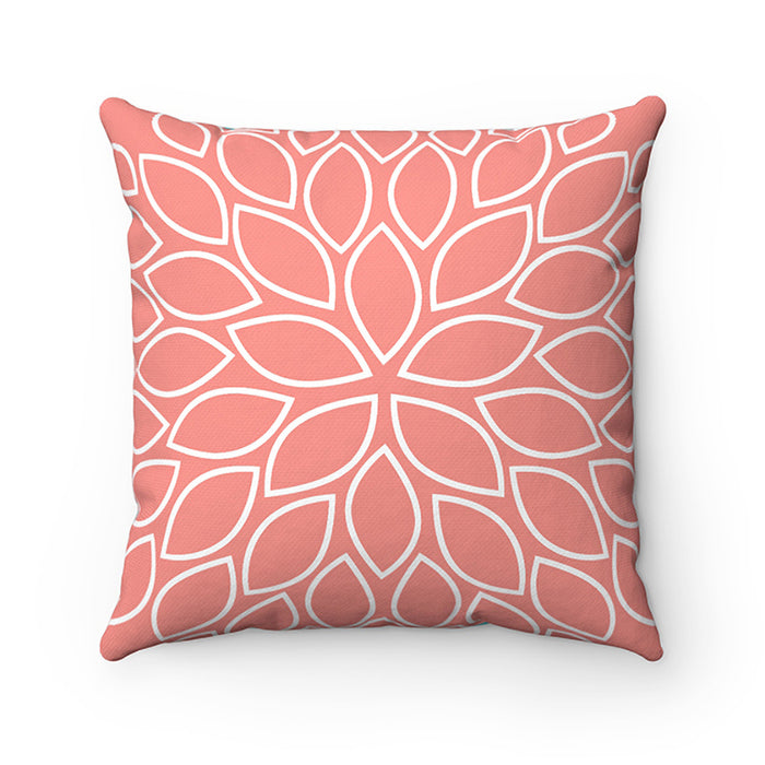 The other side of the pillow features a flower burst petal design with a coral background and transparent leaves outlined with white borders.