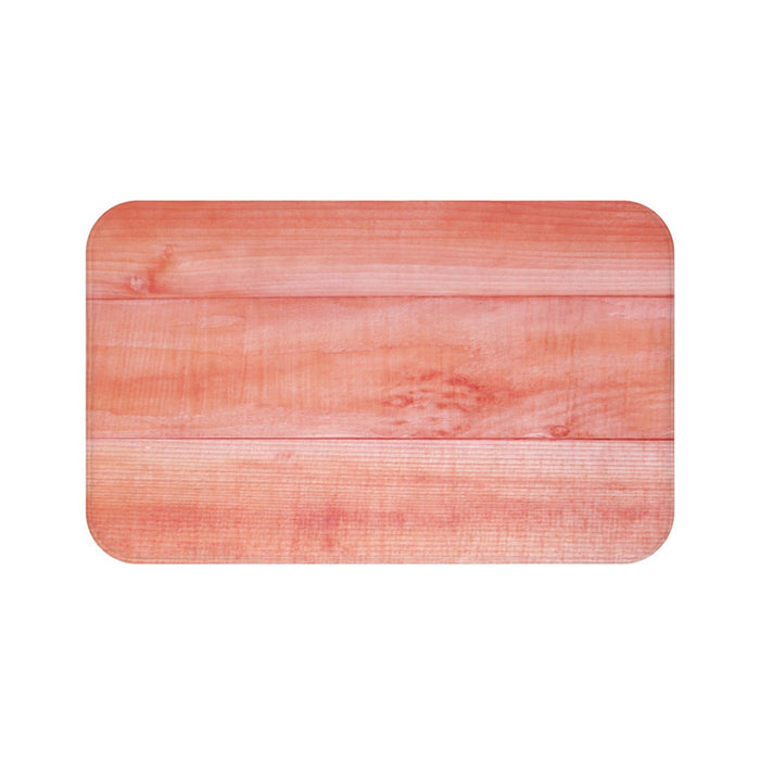 Coral hued wood plank image on a memory foam mat.