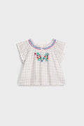 Cream Cruise Checks Perlane Blouse: Classic, airy cotton top with flutter sleeves, scalloped edges, and vibrant floral embroidery. An effortless, fun, high-end piece for your little one's wardrobe.