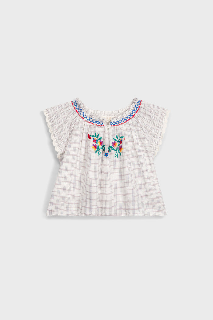 Cream Cruise Checks Perlane Blouse: Classic, airy cotton top with flutter sleeves, scalloped edges, and vibrant floral embroidery. An effortless, fun, high-end piece for your little one's wardrobe.