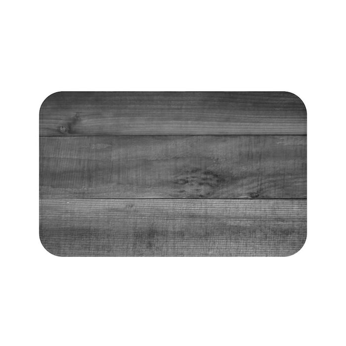 wood plank with grain pattern in dark gray on a memory foam mat.