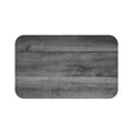 wood plank with grain pattern in dark gray on a memory foam mat.