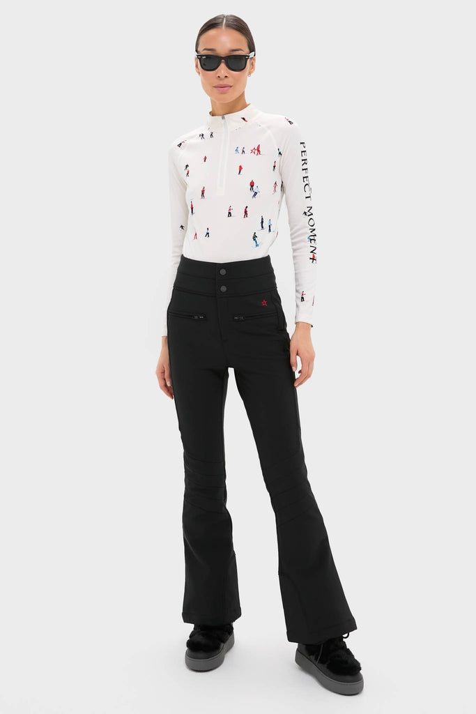 Woman models the Dede Ski Print 1/4 Zip Base Layer Top, showcasing a classic, effortless look with high-end details, perfect for fun on and off the slopes.