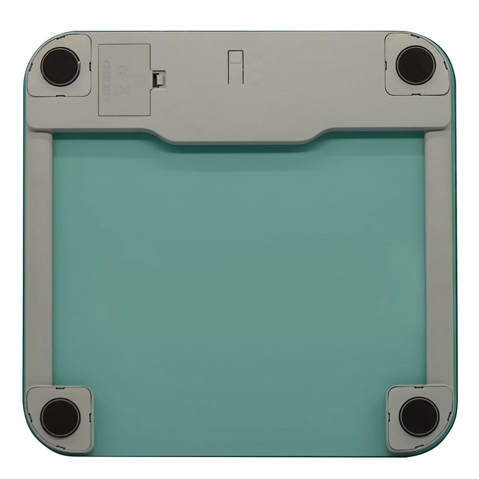 Underside view of a seafoam green digital glass scale with four round feet