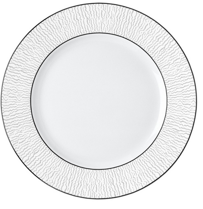 The Bernardaud Dune Dinnerware features a handcrafted white dinner plate with a textured, wavy rim and a thin silver border, inspired by classic Bernardaud designs. The center is plain and smooth for elegant dining.