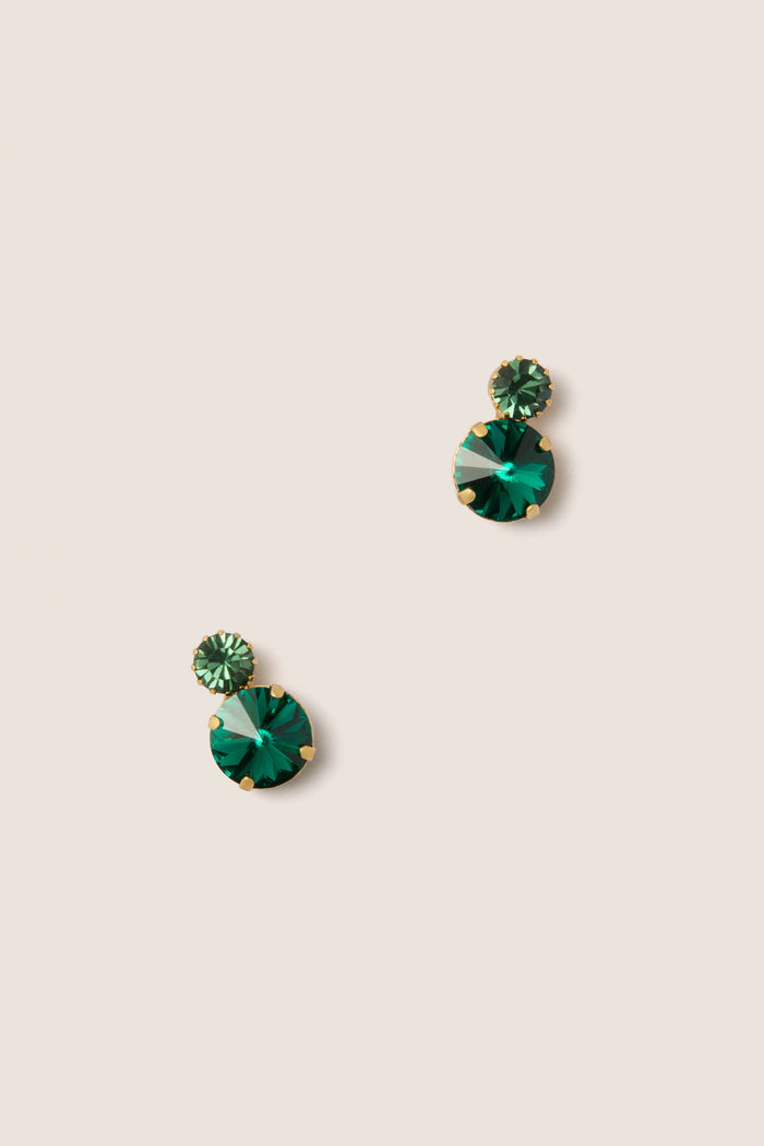 Emerald Myrla Earrings: Classic and effortless stud earrings with two faceted green gemstones in gold prongs, offering high-end sparkle for any occasion.