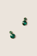 Emerald Myrla Earrings: Classic and effortless stud earrings with two faceted green gemstones in gold prongs, offering high-end sparkle for any occasion.