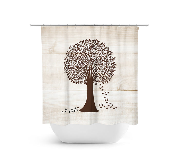 Shower curtain with three light brown wood planks as the background with a medium brown tree with foliage in a round shape and leaves falling from the right side of the tree.