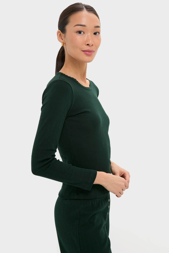 Young woman wearing the Forest Pointelle Slim Fit Long Sleeve Tee, a classic, effortless knit top with scalloped edges and eyelet details, embodying high-end, fun versatility.
