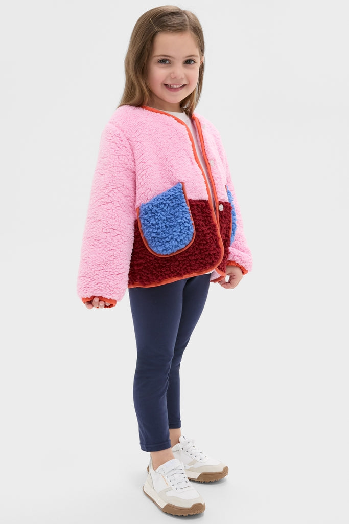 Young girl in a classic, high-end Girls Ruth Jacket, featuring effortless color-blocking and fun contrast piping, perfect for keeping cozy and stylish during fall adventures.
