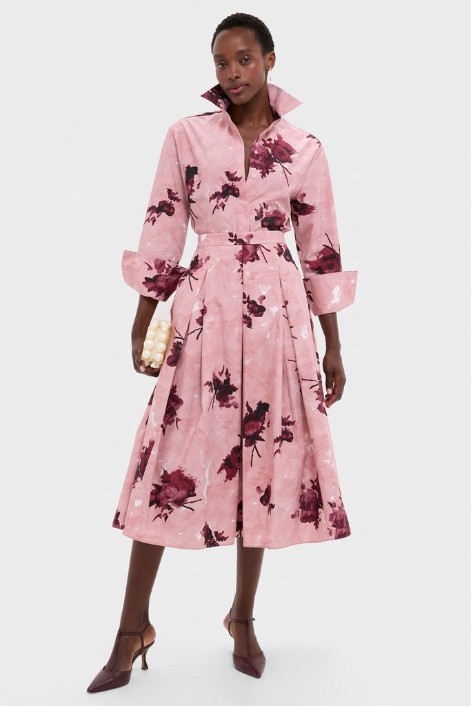 Model in a classic fit-and-flare midi dress with Gold Maryanne Earrings, holding a pearl clutch, exuding effortless, high-end style with fun burgundy T-strap heels.