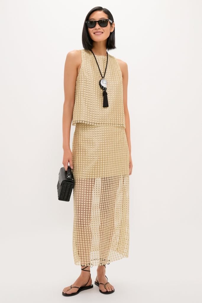 Woman models Gold Metallic Star Lace Keating Top, a classic, sleeveless, boxy, shimmering lace design paired with matching sheer maxi skirt, exuding effortless, high-end style.