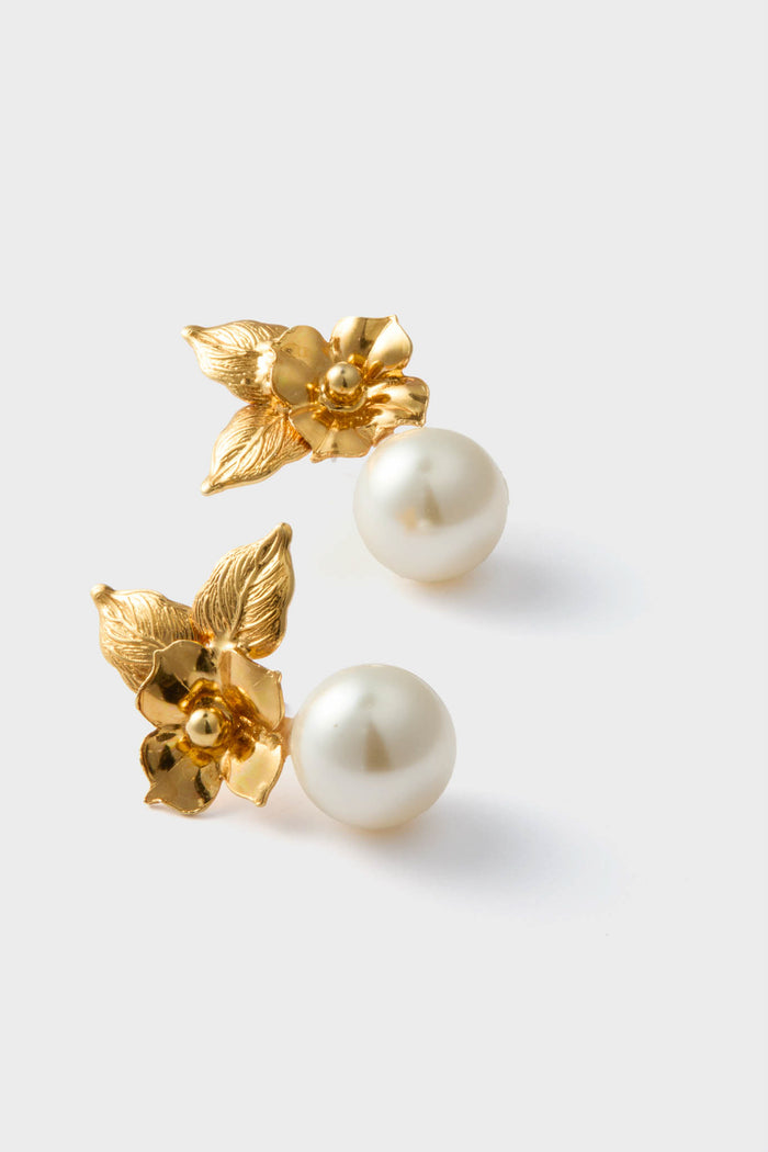 Gold Rici Earrings: classic gold-tone flowers with textured petals and creamy pearl drops, effortlessly blending high-end craftsmanship and fun, sculptural elegance. Handcrafted in New York.