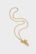 Gold The Family of Hearts Pendant: A classic gold-tone chain necklace with an effortless cluster of heart charms, featuring ruby crystal pave details and a high-end lobster clasp closure.