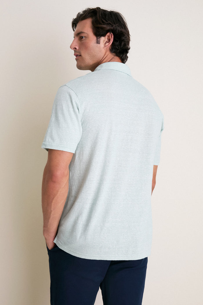 A man in a Grandview Linen Sanibel Polo exudes effortless style with its classic, lightweight design, perfect for fun, high-end adventures.