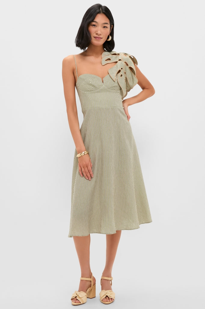 Woman models the Green Striped Monstera Leaf Sleeveless Midi Dress with sculptural ruffle, paired with gold bangles and woven platform sandals for an effortless, high-end look.