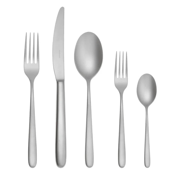 The Sambonet Hannah Antico Flatware 5 Piece Setting features a dinner fork, dinner knife, soup spoon, salad fork, and teaspoon with simple handles, arranged in a row on a white background.