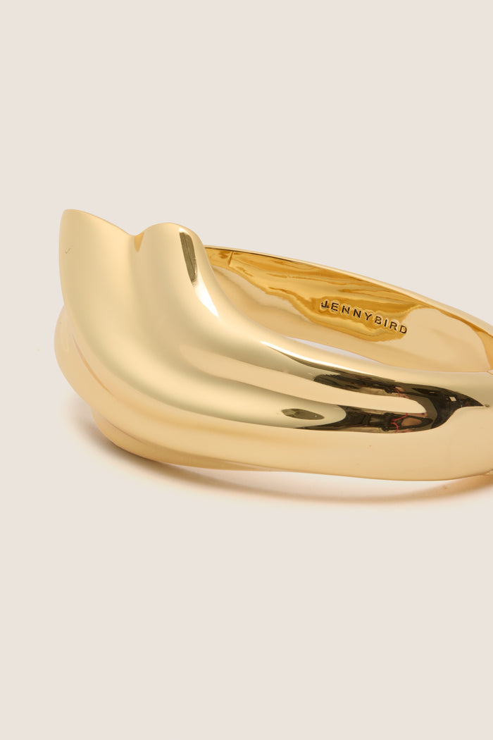 High Polish Gold Lydia Cuff: A classic, sculptural gold-tone piece with overlapping bands, effortlessly blending fun and high-end style for an elevated, versatile look.