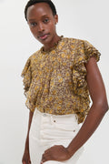 Model wearing the Khaki Daliyane Top, a classic, effortless, high-end blouse with ruffle trim and yellow floral print, paired with fun, high-waisted jeans.
