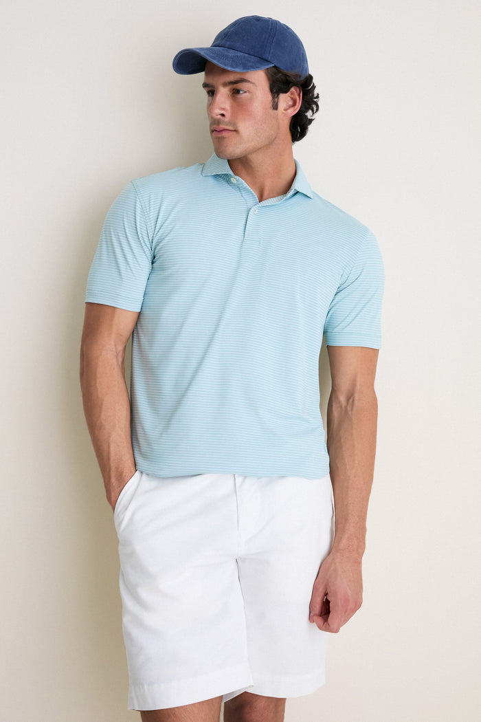 Man wearing the classic Light Willow Ballad Performance Jersey Polo, showcasing its effortless style and tailored fit, perfect for a fun, high-end look.