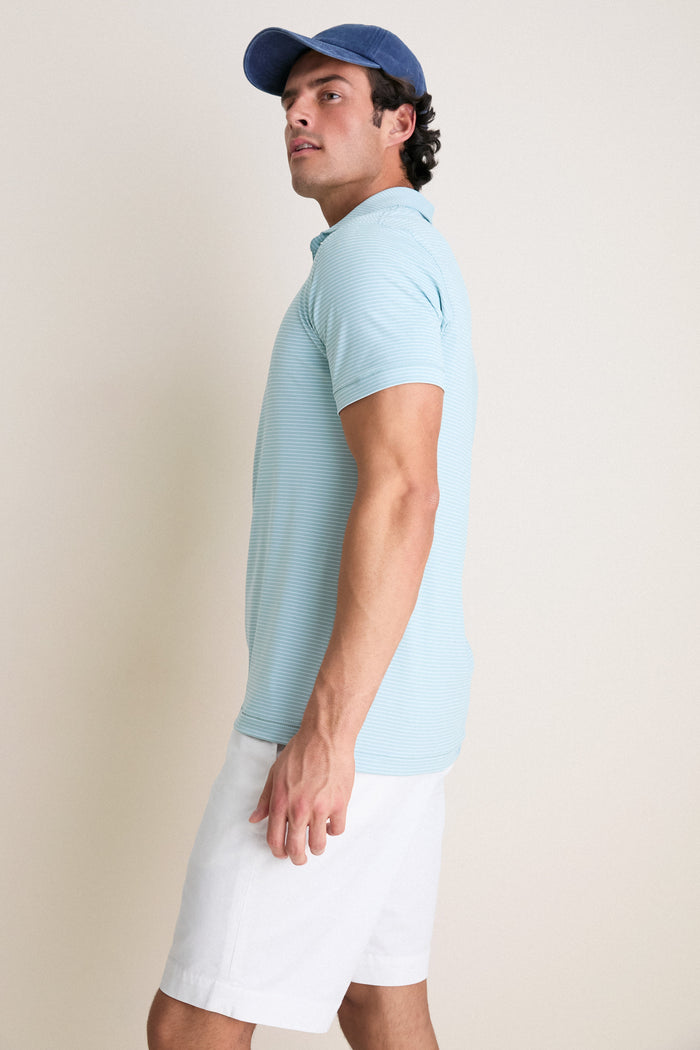 Young man models the classic Light Willow Ballad Performance Jersey Polo, showcasing its effortless, high-end style and technical features, perfect for a fun, casual look.