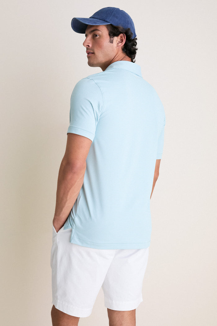 Man wearing Light Willow Ballad Performance Jersey Polo, classic and effortless with subtle stripes, showcasing high-end comfort and fun style, perfect for versatile, confident wear.