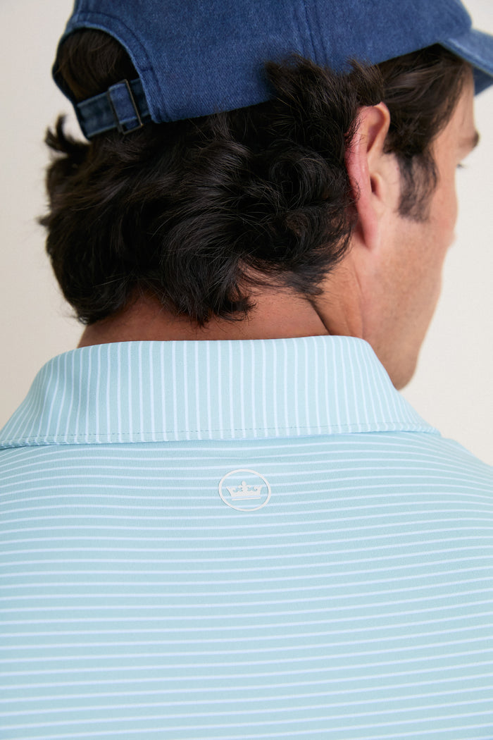 Back view of a man wearing the Light Willow Ballad Performance Jersey Polo, showcasing its classic, effortless style with a tailored fit and high-end craftsmanship.