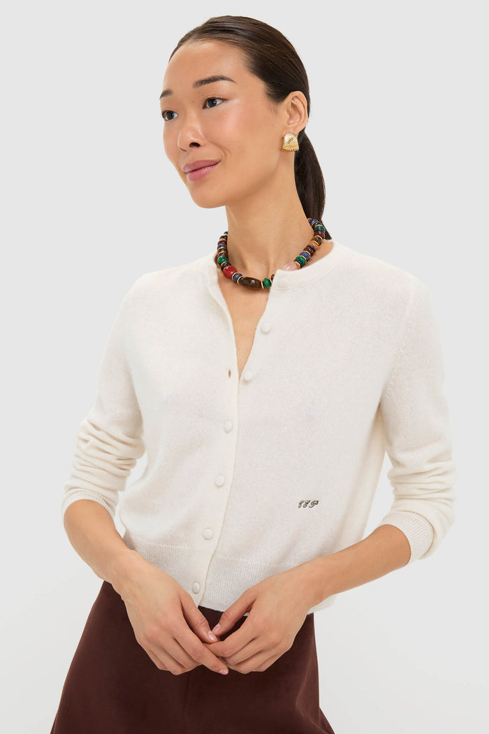 Woman wearing Mixed Stone Francis Necklace, featuring vibrant stones, with a classic cream cardigan and dark bottoms; an effortless, high-end statement piece for a fun, confident look.