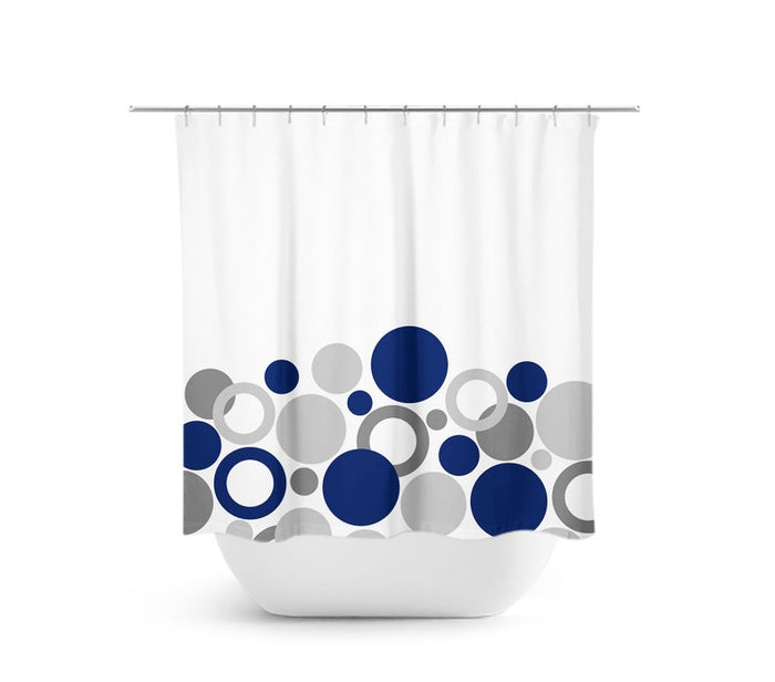 Shower curtain with geometric bubbles and circles. Bubbles and circles are navy blue, medium gray, and light gray. The background is white. Bubbles are on the bottom half of the shower curtain.